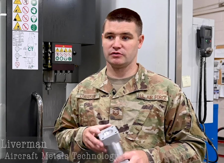 Lance Liverman at work. Man standing in USAF uniform. 